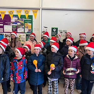 children singing in Santa hats